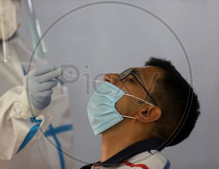 A Health Worker Collects A Swab Sample From A Man At A Covid-19 Testing Centre, Near Asaf Ali Road, On June 22, 2020 In New Delhi, India.