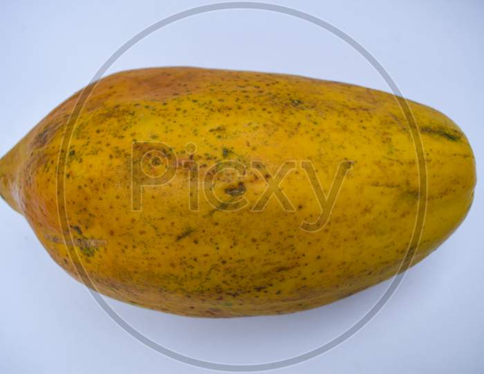 Top View Of Fresh Yellow Ripe Papaya Or Papaw Fruit Closeup On White Background