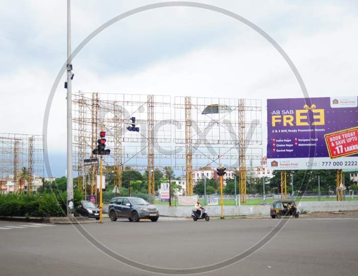 Vacant hoarding and signage frame structures at a crossroad junction