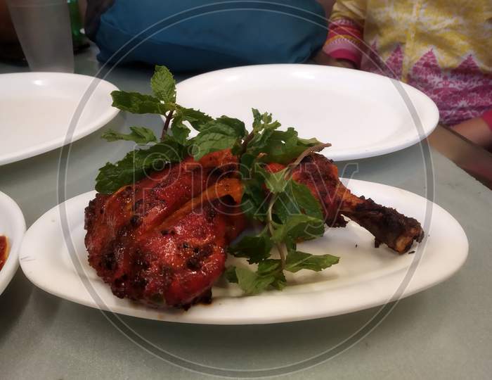 Delicious tandoori chicken leg decorated food