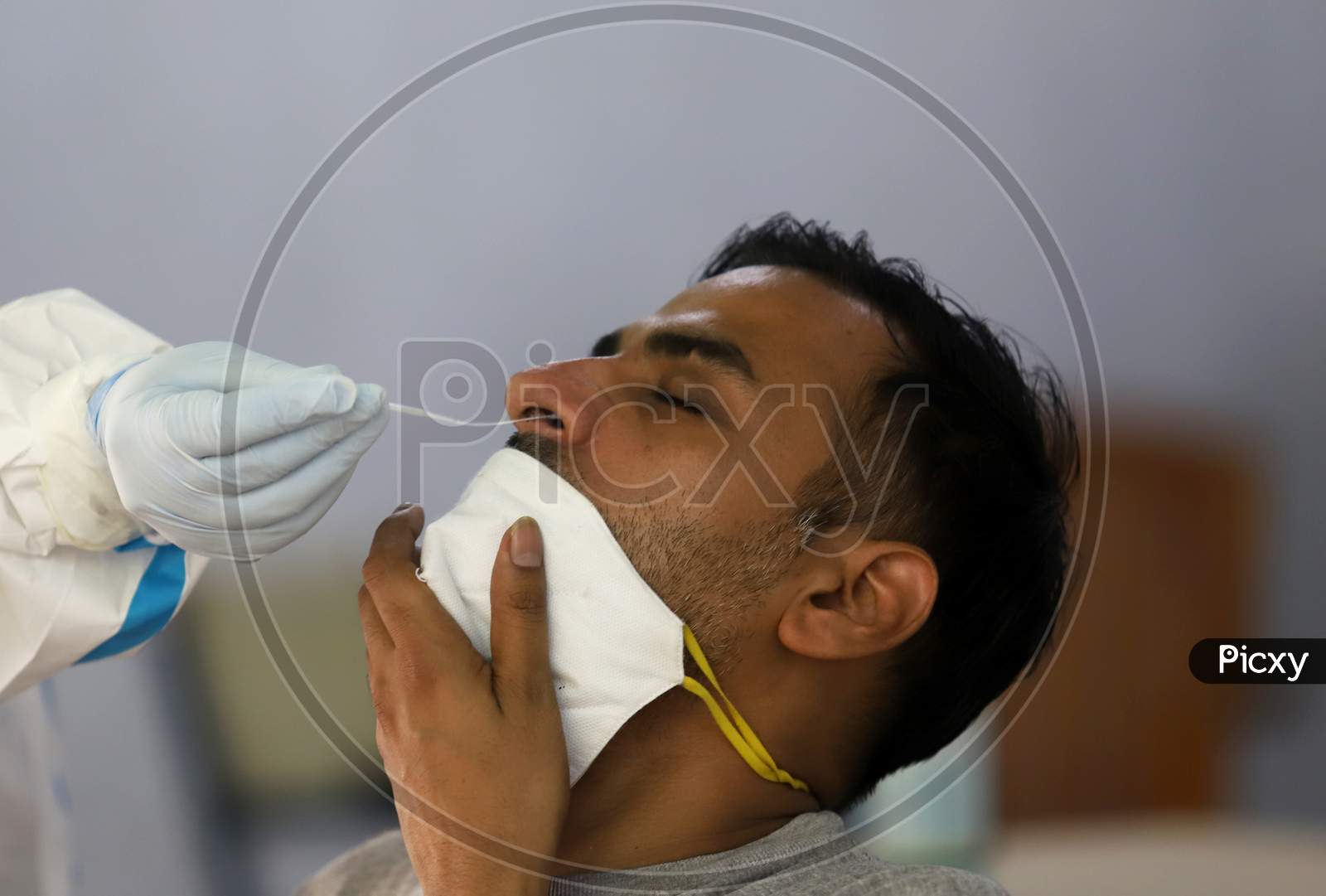 A Health Worker Collects A Swab Sample From A Man At A Covid-19 Testing Centre, Near Asaf Ali Road, On June 22, 2020 In New Delhi, India.