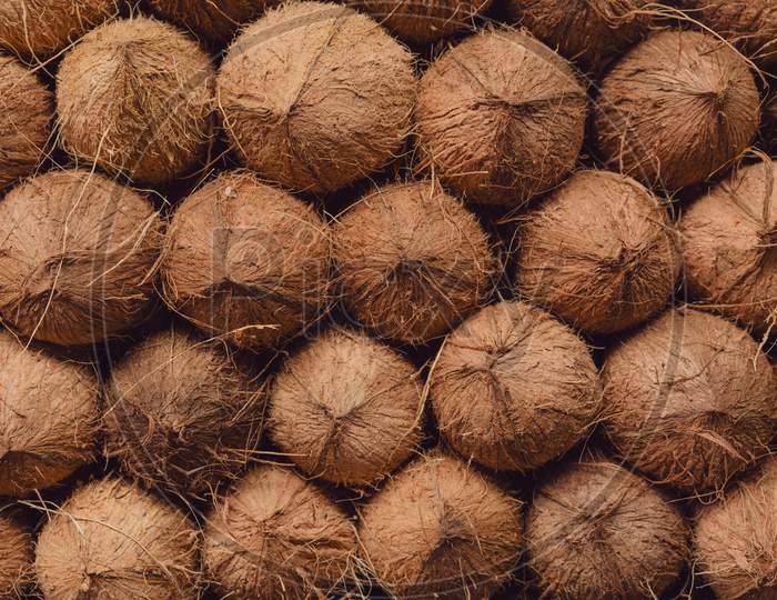 Coconut pile, neatly arranged for sale in a local market