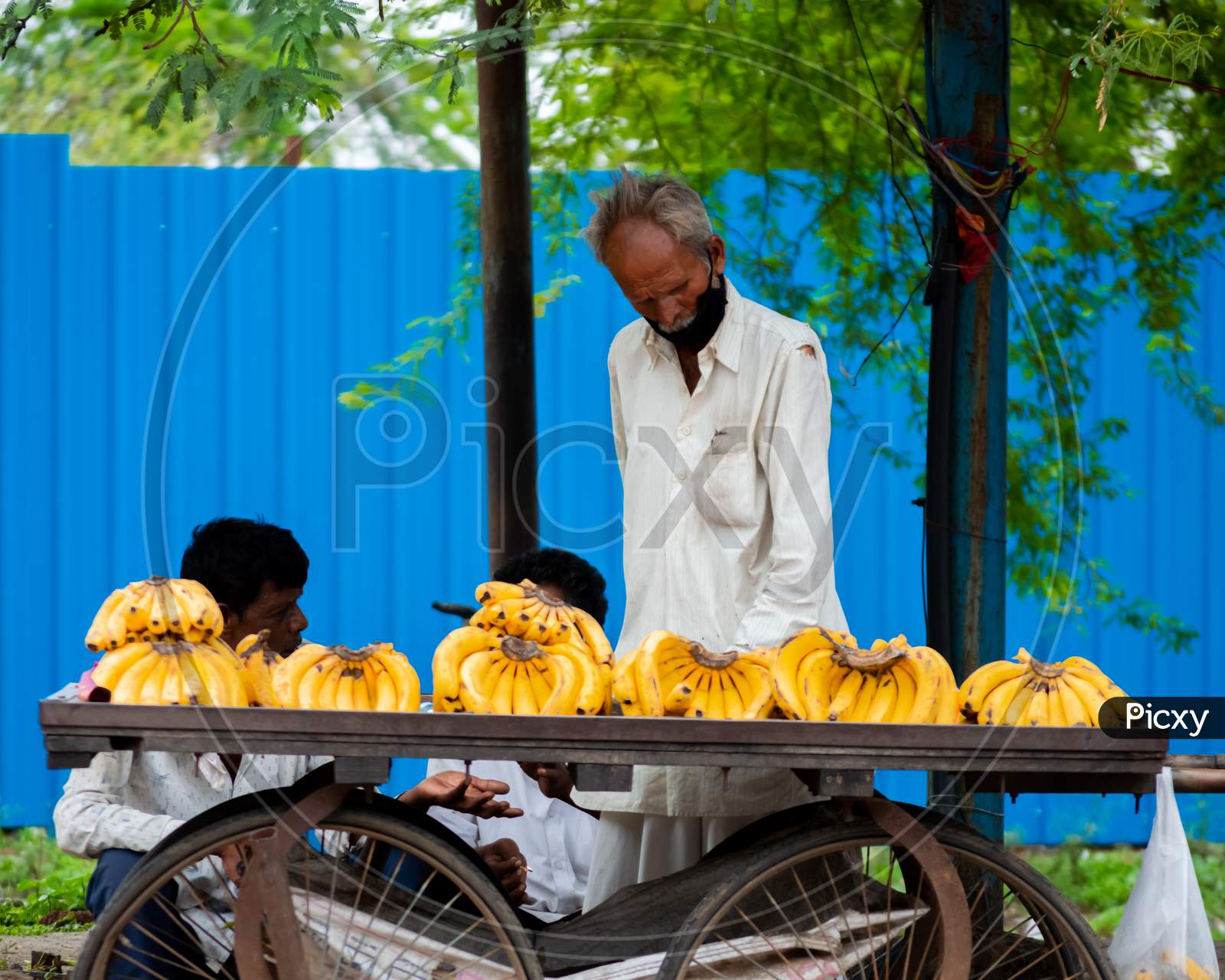 Old man selling fruits on the street.