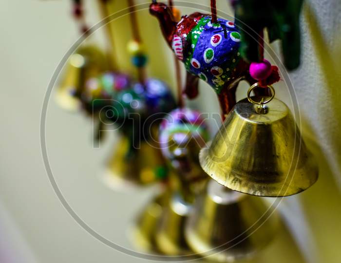 Golden Colored Bells And Elephant Soft Toys . Selective Focusing On The Bell And A Elephant Toy