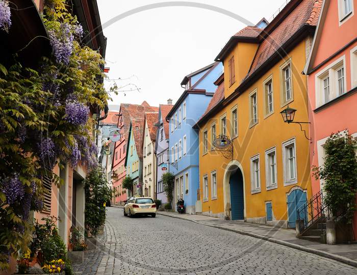 Flowers On Houses On Colorful Street In Germany