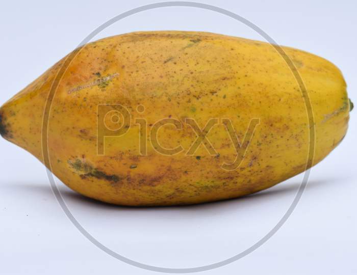 Side View Of Fresh Yellow Ripe Papaya Or Papaw Fruit Closeup On White Background