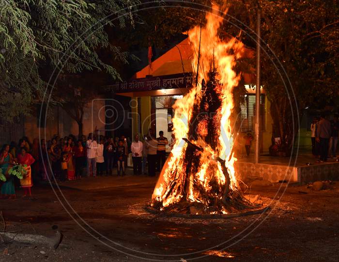 Bonfire of dry branches and palm leaves being burnt on the eve of the Holi