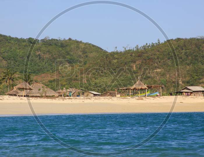 Touristic Indonesian Huts On Beach In Kuta Lombok