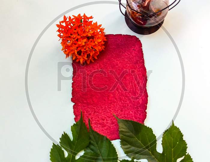 Letter,empty texture paper with mulberry leaves,red flower.wedding cards or invitation card.writing concept,vacation concept.flat lay,overhead view,top view.space for text.