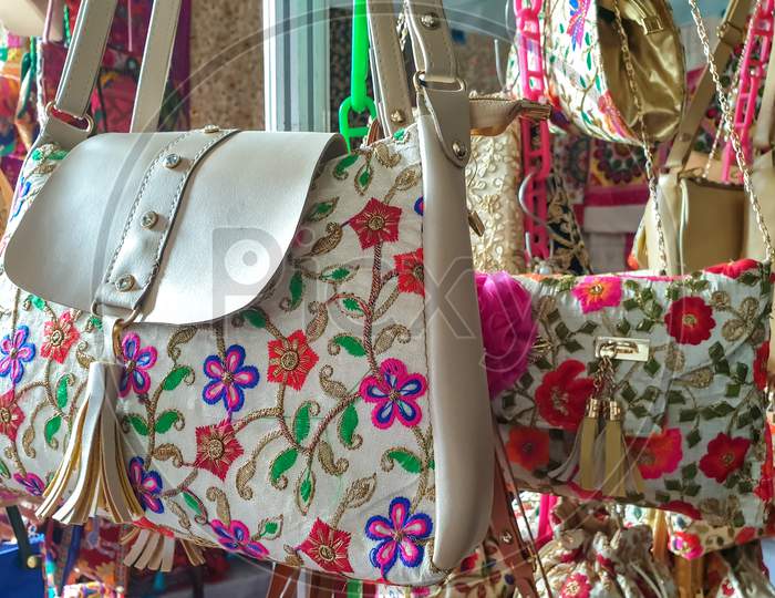 Mandi, Himachal Pradesh / India - February 28 2020: Photo of beautiful Rajasthani flowers artwork hand bags hanging in shop