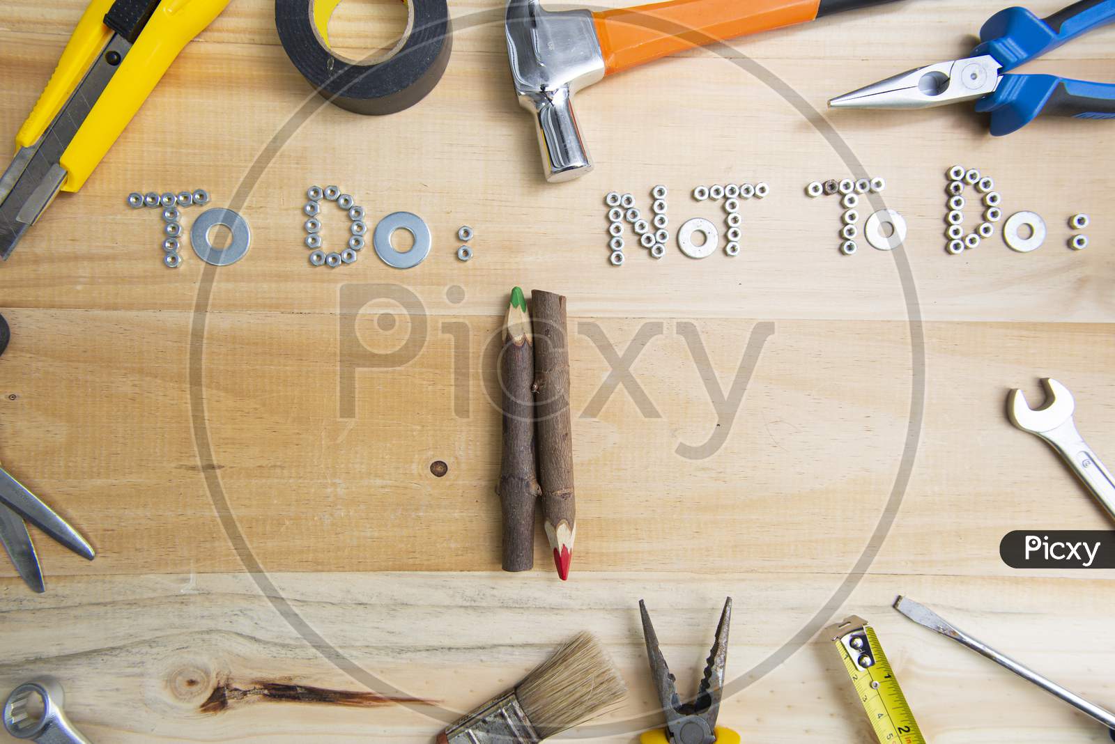 A High Angle Shot Of The Phrases "To Do" And "Not To Do" Made Of Screws On A Wooden Surface For Planning The Work. Construction Tools Framing Wooden Background Shot From Above.