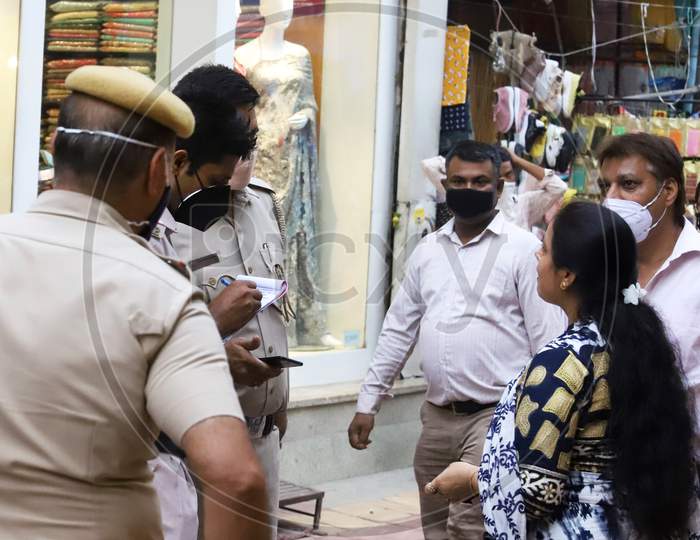 Delhi Police fines people for violation of lockdown measures for not wearing face masks, at Lajpath Nagar market, On June 20, 2020 In New Delhi, India.