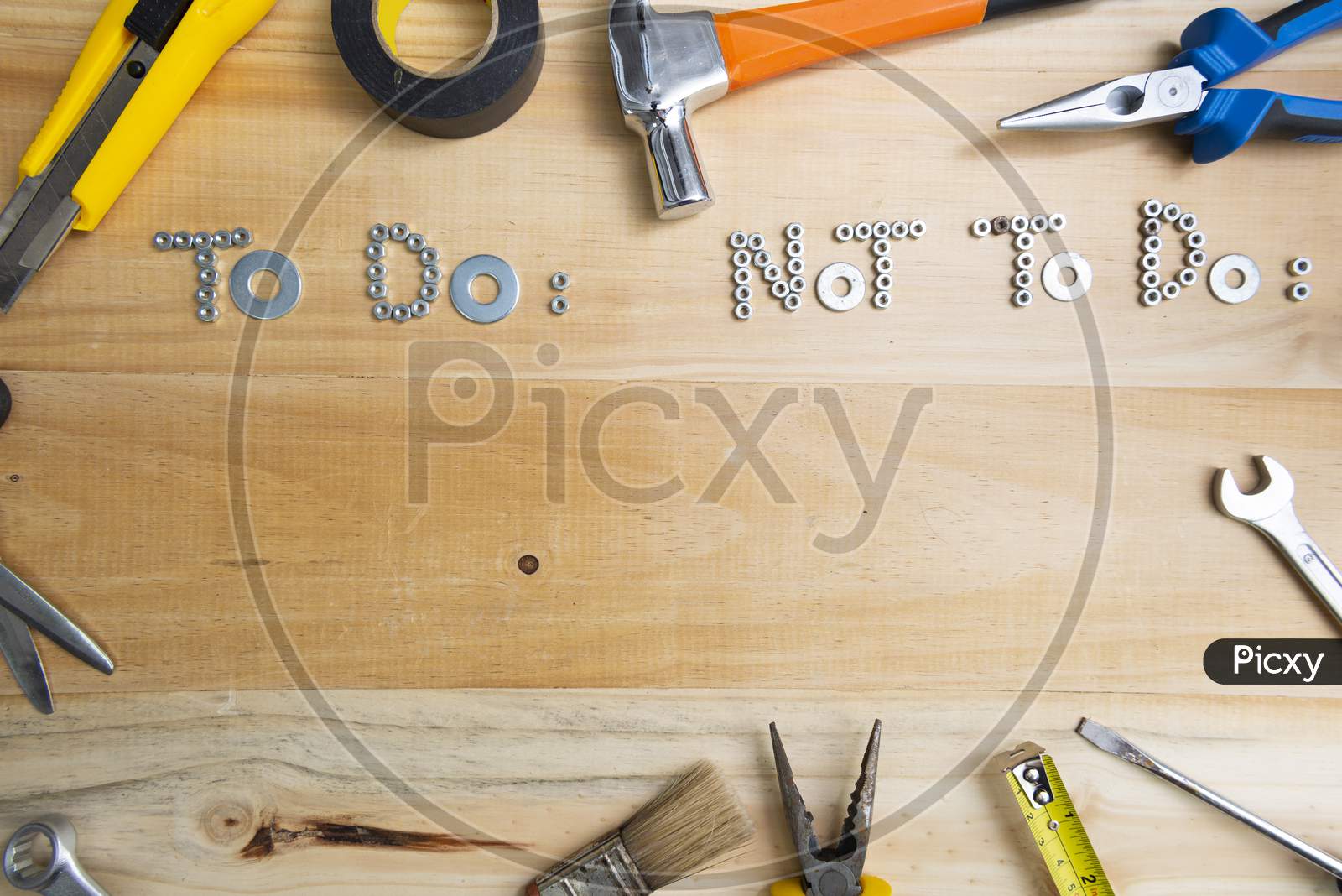 A High Angle Shot Of The Phrases "To Do" And "Not To Do" Made Of Screws On A Wooden Surface For Planning The Work. Construction Tools Framing Wooden Background Shot From Above.