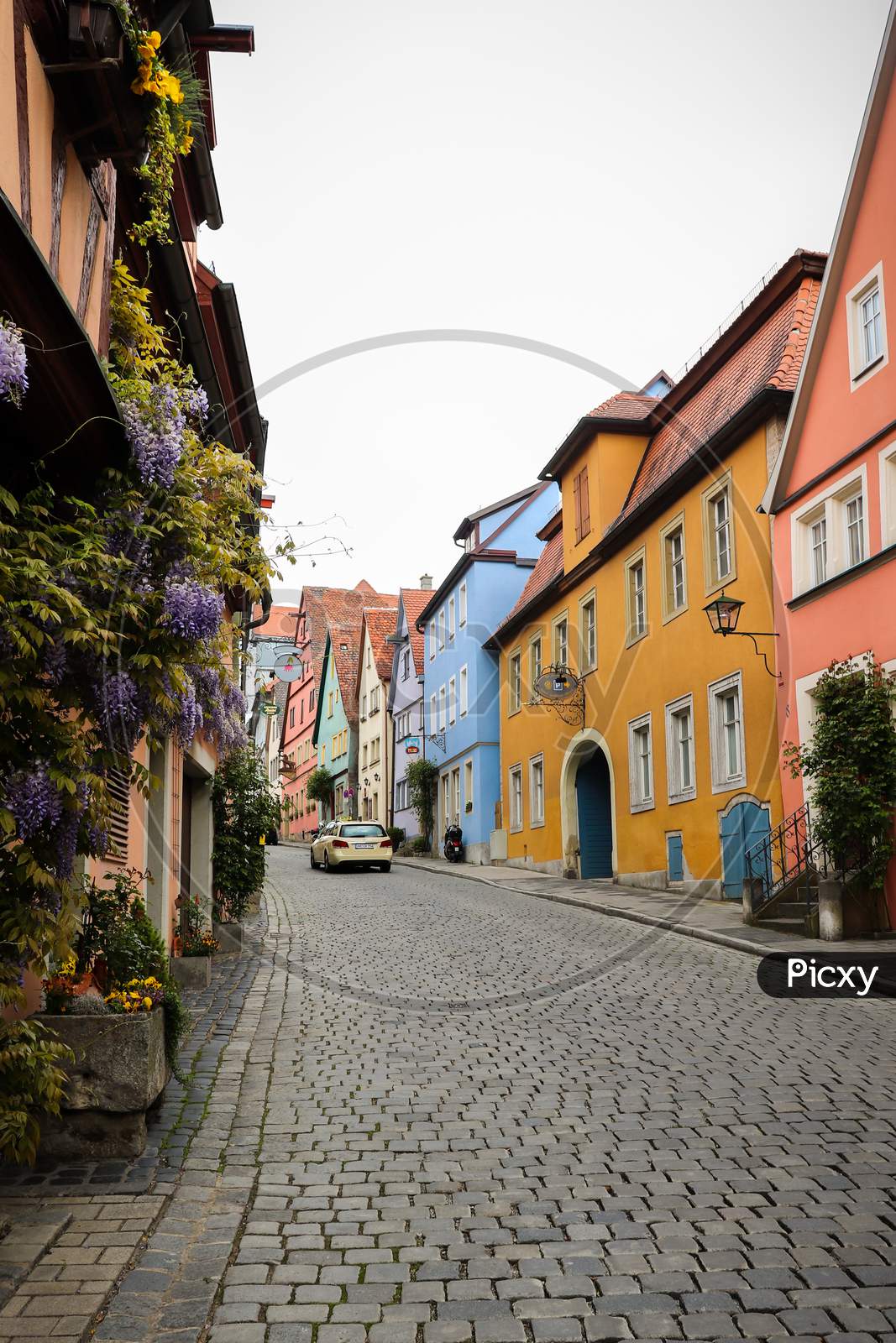 Flowers On Houses On Colorful Street In Germany