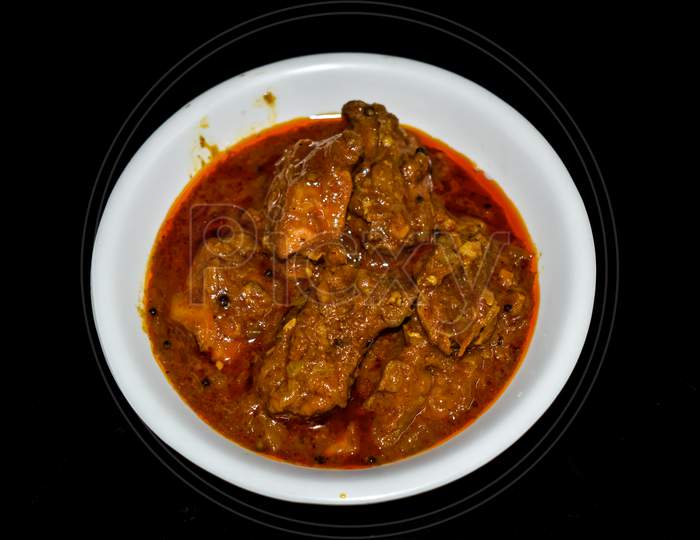 South Indian Cuisine Kerala Style Beef Curry / Roast. Traditional Style Meat Curry On Black Background. Indian Spicy Curry. Selective Focus Photograph.