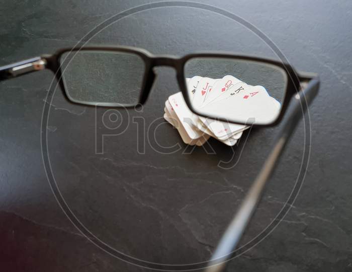 Glasses And Deck Of Playing Cards On Table
