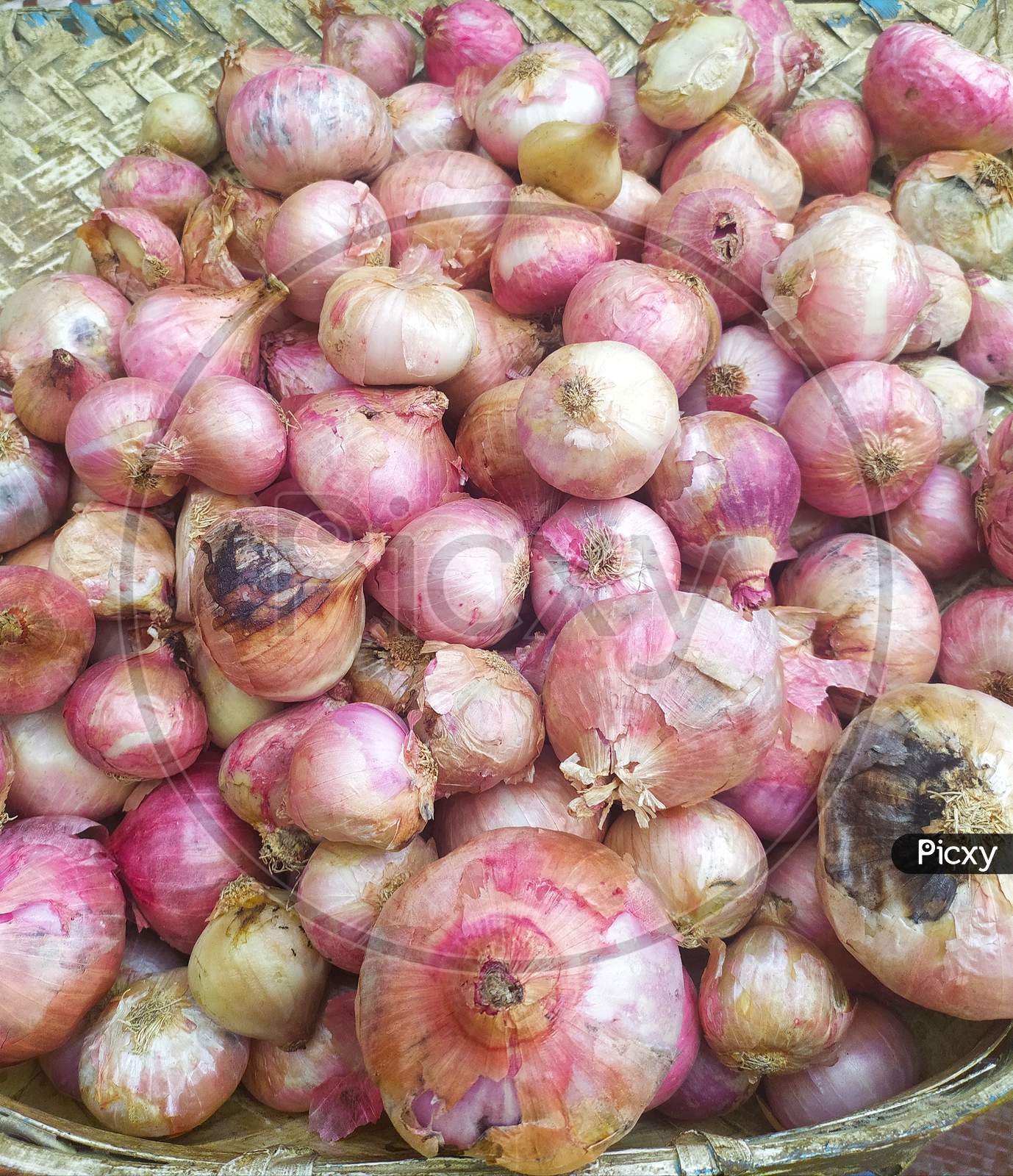 fresh pink onions as a background. In a marketplace