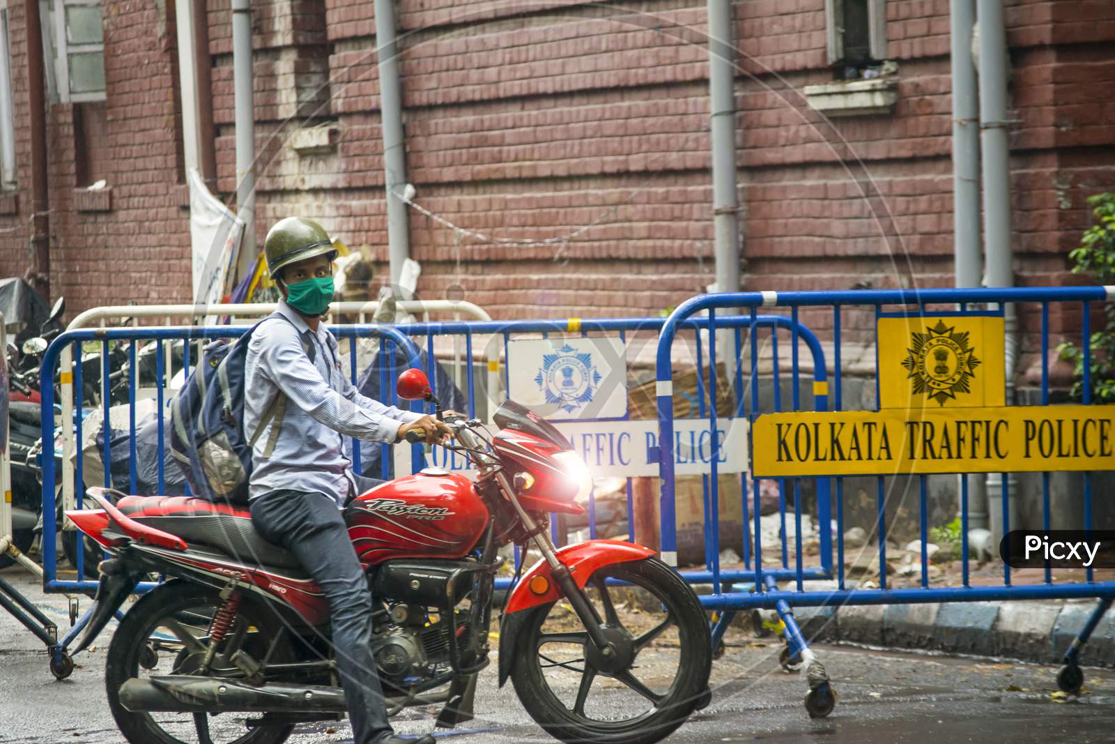 A Police person riding on a bike  while raining in kolkata near Lalbazar Police Headquarters on 21st June 2020 at Kolkata, West Bengal, India