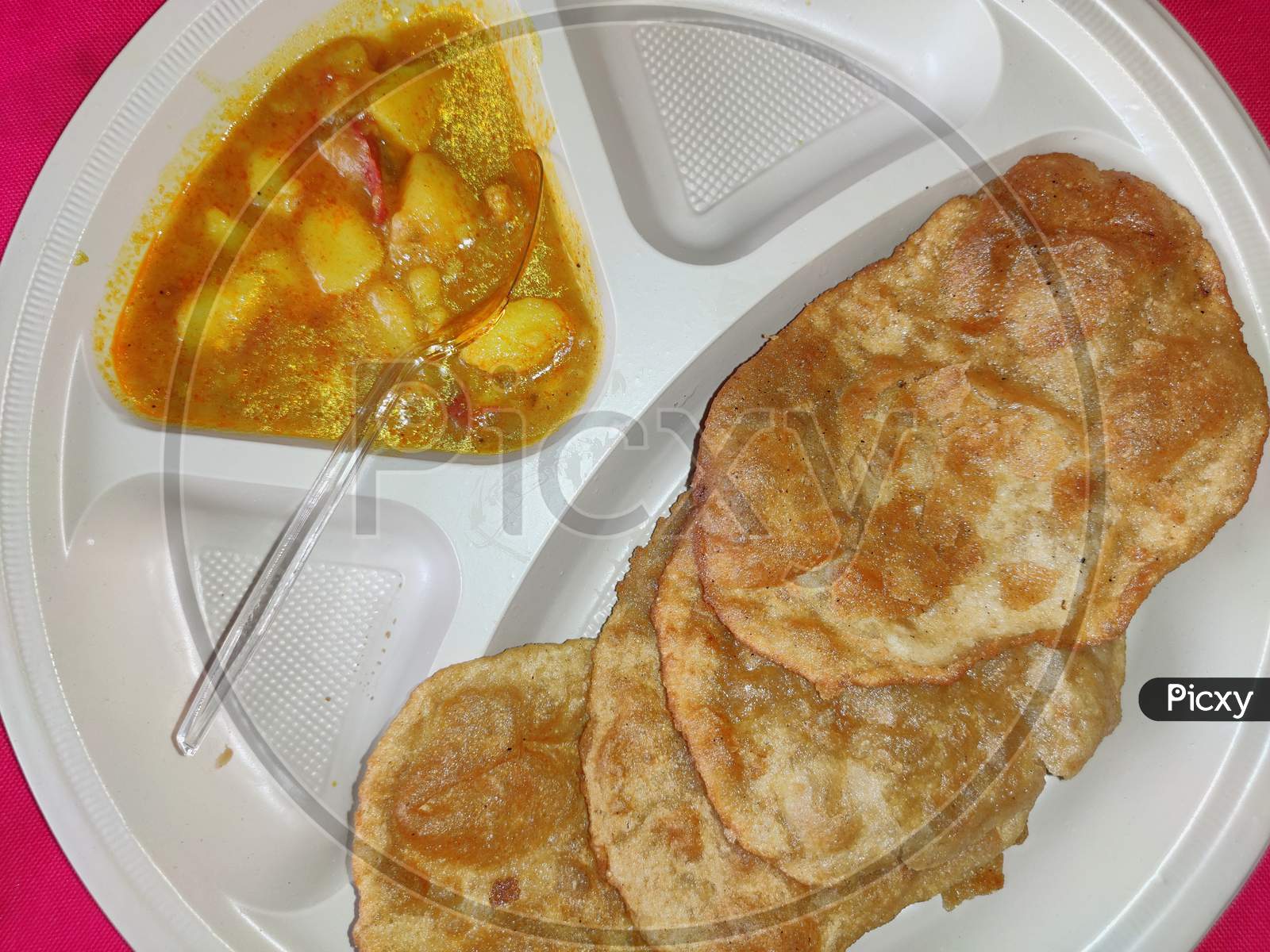 Puri and Potato Curry aalu sabji in plate Close-up- an indian cuisine in round plate.