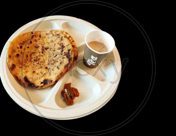 Chai paratha with mango pickle in plate top view indian  breakfast