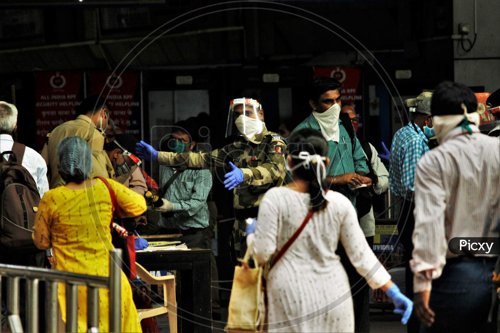 A CRPF official instructs the commuters to maintain social distancing, at Churchgate station, after the government eased a nationwide lockdown imposed as a preventive measure against the COVID-19 coronavirus, at Churchgate station, in Mumbai, India, on June 16, 2020.