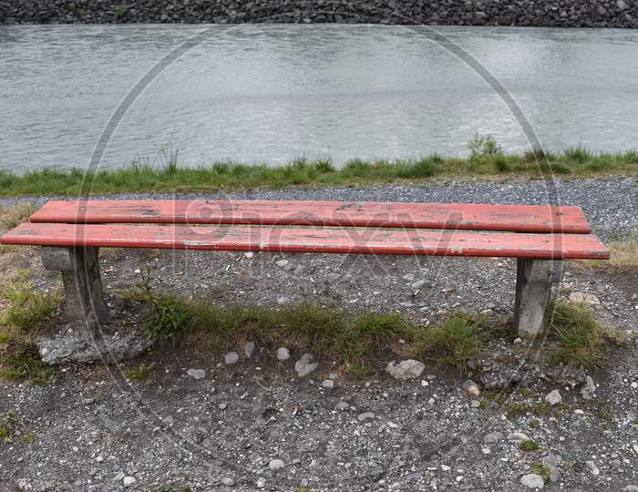 Empty red bench at the rhine river in Switzerland 3.5.2020