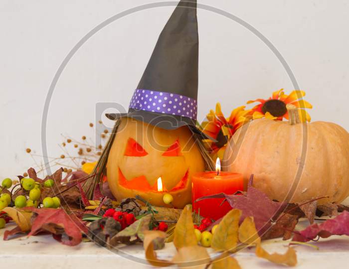 Candles And Decoration With Halloween Pumpkins With Witch Faces And Witch