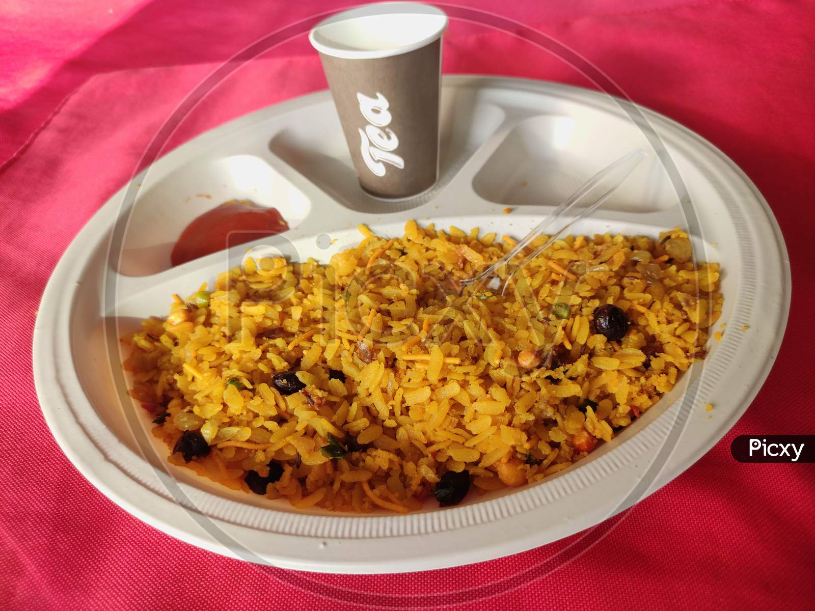 poha or aalu poha or pohe made up of beaten rice or flattened rice, favourite indian snack taken with tea in plate