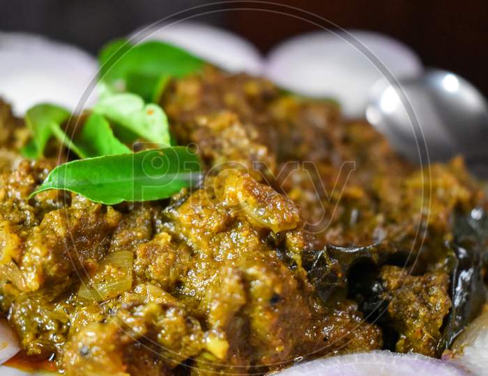 South Indian Cuisine Kerala Style Beef Fry / Roast. Traditional Style Meat Roast. Garnished With Onion Slices And Curry Leaves. Selective Focus Photograph.