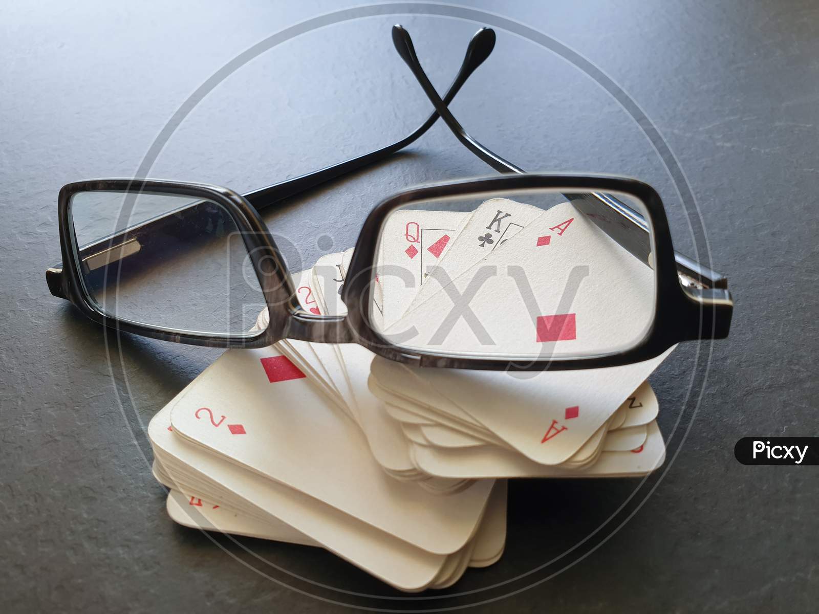 Glasses And Deck Of Playing Cards On Table