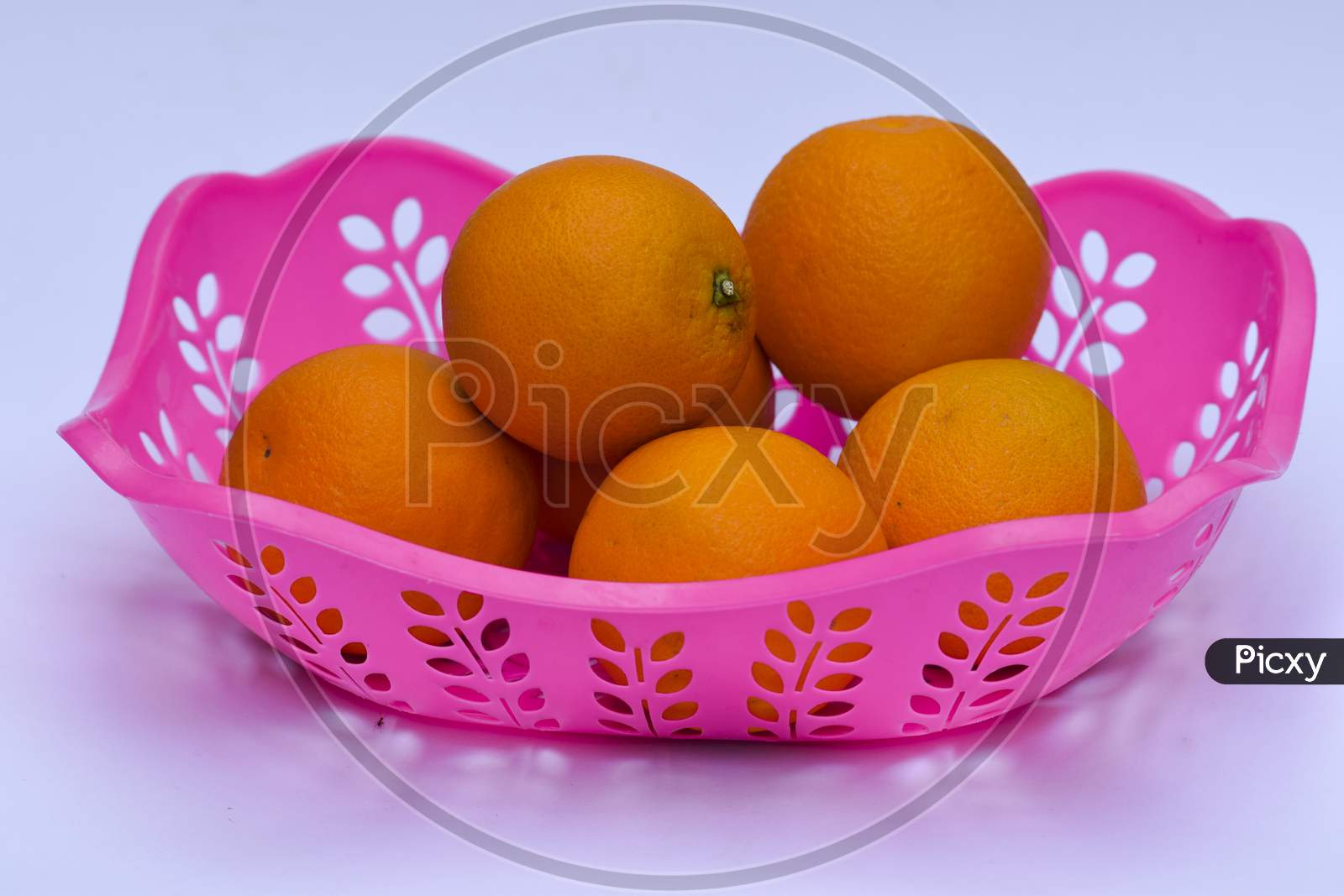 Mandarin Fruit Heap On White Background In Pink Basket. Fresh Fruits From India Asia