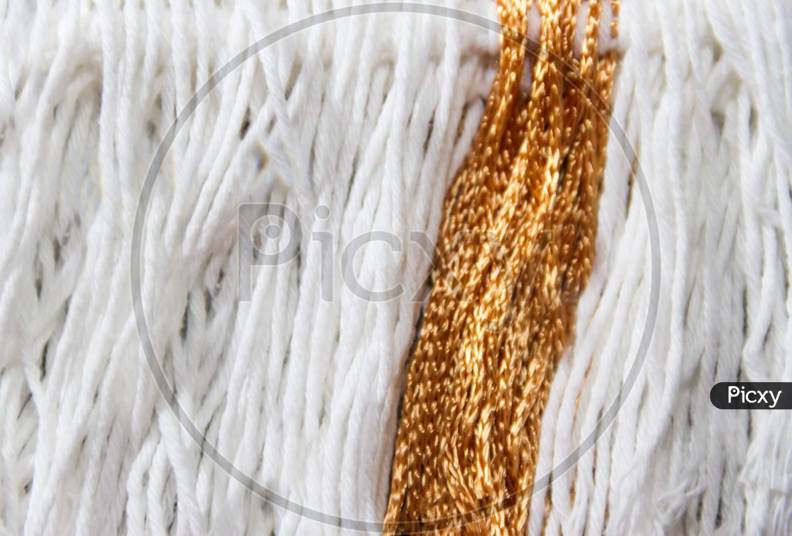 Texture Of Wool Fringe And White And Gold Threads
