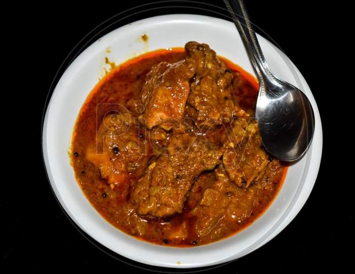 South Indian Cuisine Kerala Style Beef Curry / Roast. Traditional Style Meat Curry On Black Background. Indian Spicy Curry. Selective Focus Photograph.