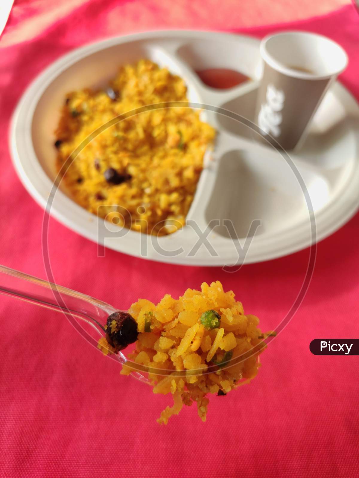 poha or aalu poha or pohe made up of beaten rice or flattened rice, favourite indian snack taken with tea in plate