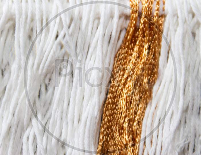 Texture Of Wool Fringe And White And Gold Threads