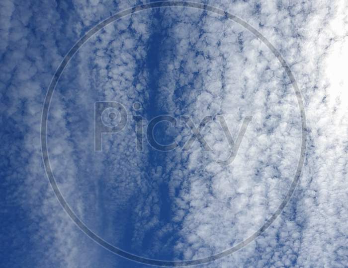 White Clouds Texture Pattern In Vertical Blue Sky