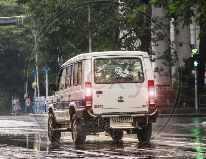 A Police car running on road  while raining in kolkata near Lalbazar Police Headquarters on 21st June 2020 at Kolkata, West Bengal, India