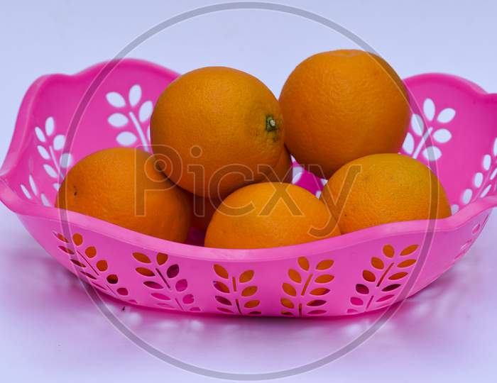 Mandarin Fruit Heap On White Background In Pink Basket. Fresh Fruits From India Asia