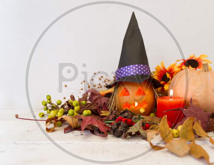 Candles And Decoration With Halloween Pumpkins With Witch Faces And Witch