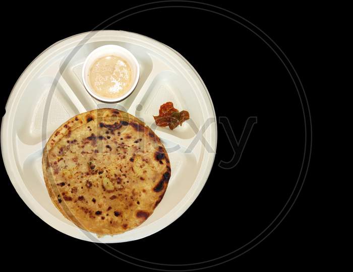 Chai paratha with mango pickle in plate top view indian  breakfast