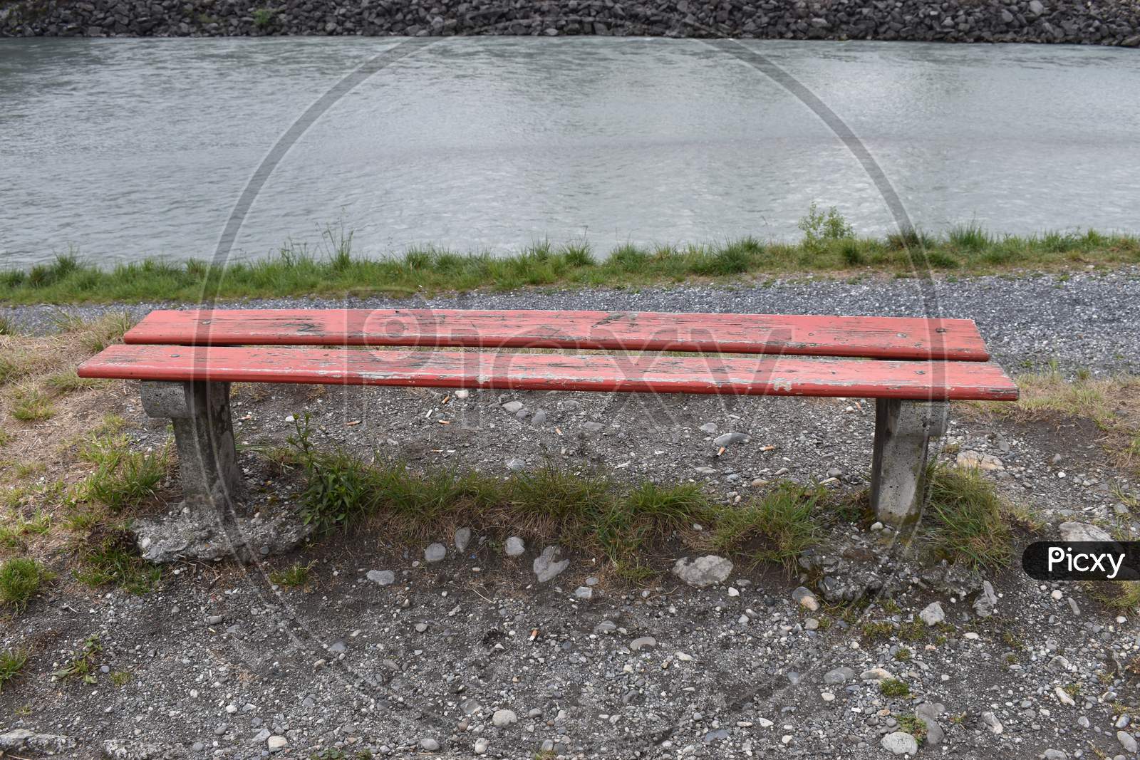 Empty red bench at the rhine river in Switzerland 3.5.2020