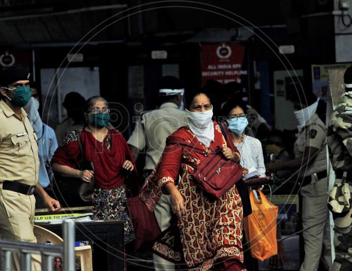 Commuters walk on a platform as they arrive to board trains scheduled for essential service workers after the government eased a nationwide lockdown that was imposed as a preventive measure against the COVID-19 coronavirus, at Churchgate station, in Mumbai, India, on June 16, 2020.