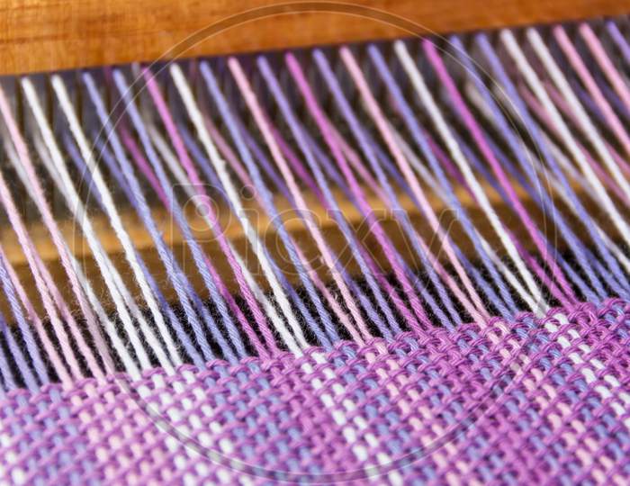 Detail Of Fabric In Comb Loom With Ultraviolet And Lilac Colors