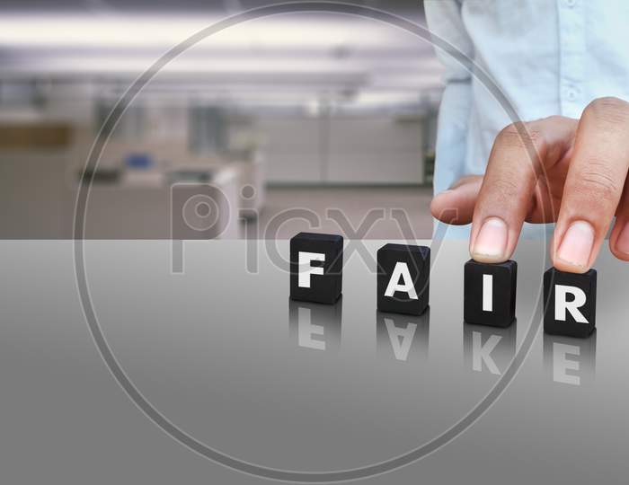 A Male Person Putting Cubes Labeled With Fair Text And Fake In Reflection Conceptual Image On Social Media Day