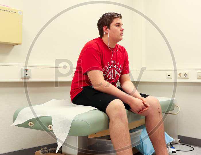 Teenager Sitting On Hospital Bed
