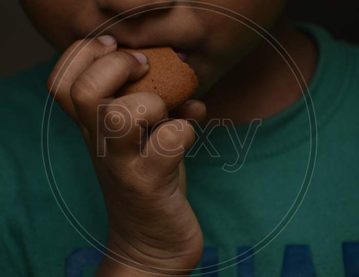 child eating delicious chocolate cookies.