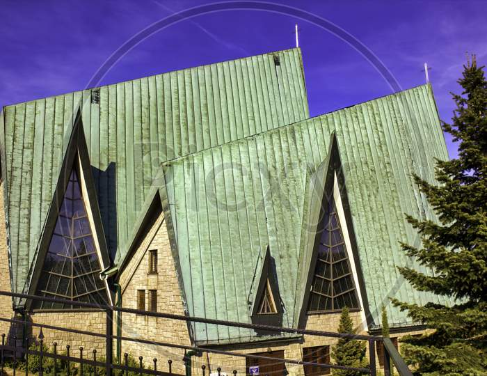 A Closeup Of A Modern Pointed Architecture Of A Church Near Small Town Named Limanowa, Located In South Poland, Europe