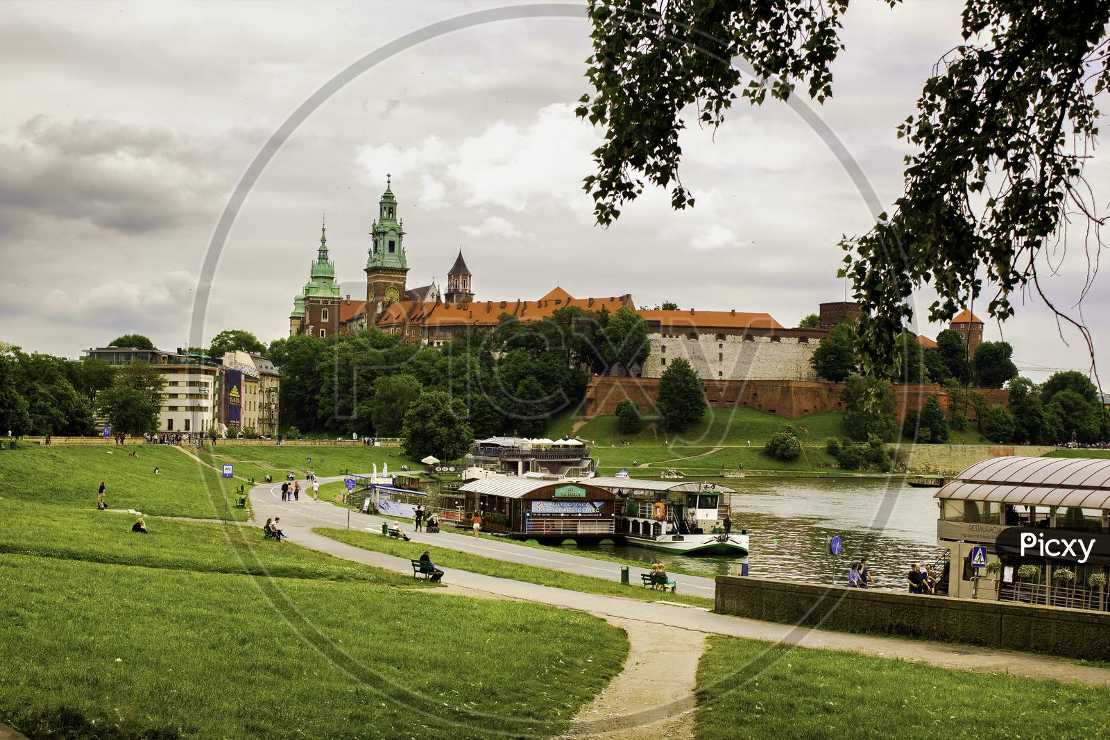 Landscape Of A Wawel Castle Next To Vistula River Against Dramatic Cloud Located In Krakow City Center In Poland, Europe