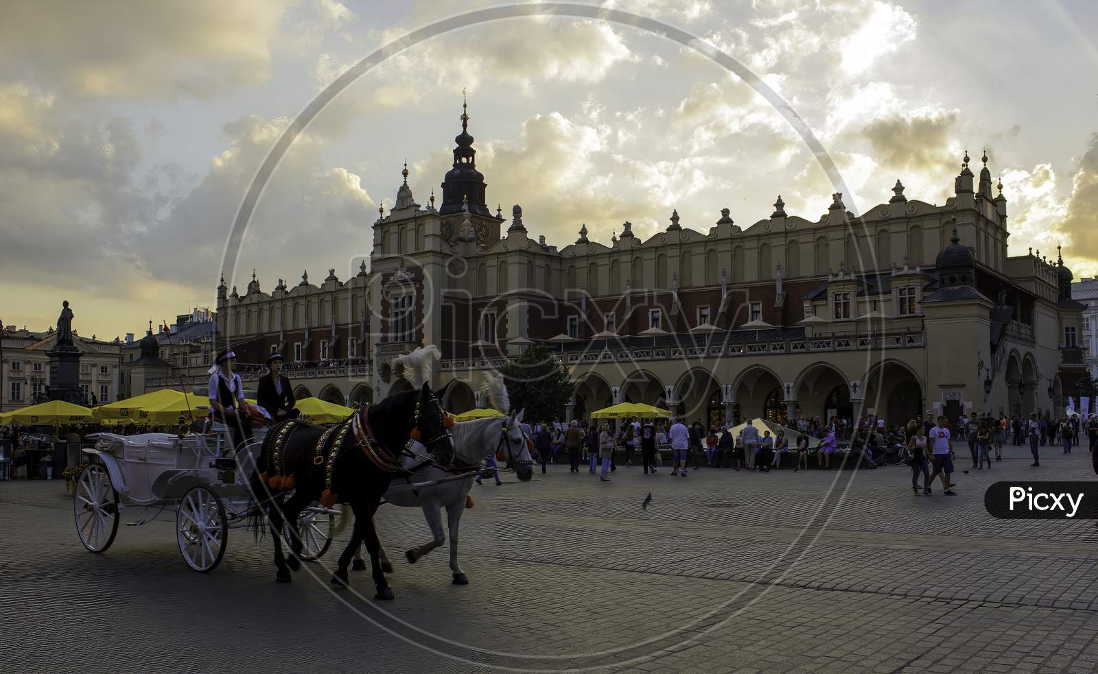 Krakow, Poland - May 23, 2014: A Wide Angle Street View Of Horse Ride In The Touristic Main Square At The Center Of Krakow City In Poland