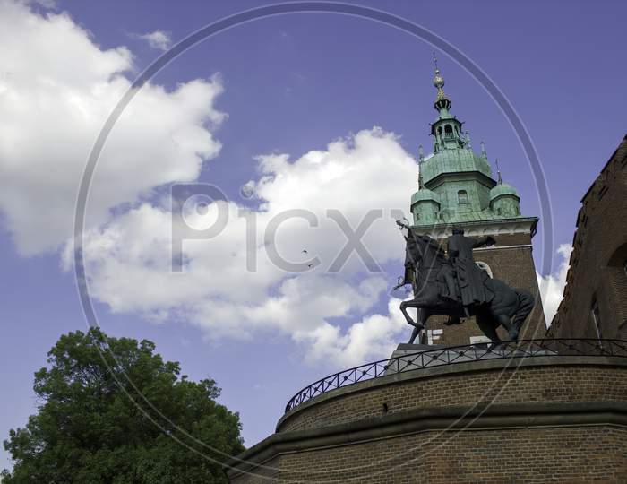 A Monument In Wawel Castle Tower Against A Blue Sky Located In Krakow City In South Poland, Europe